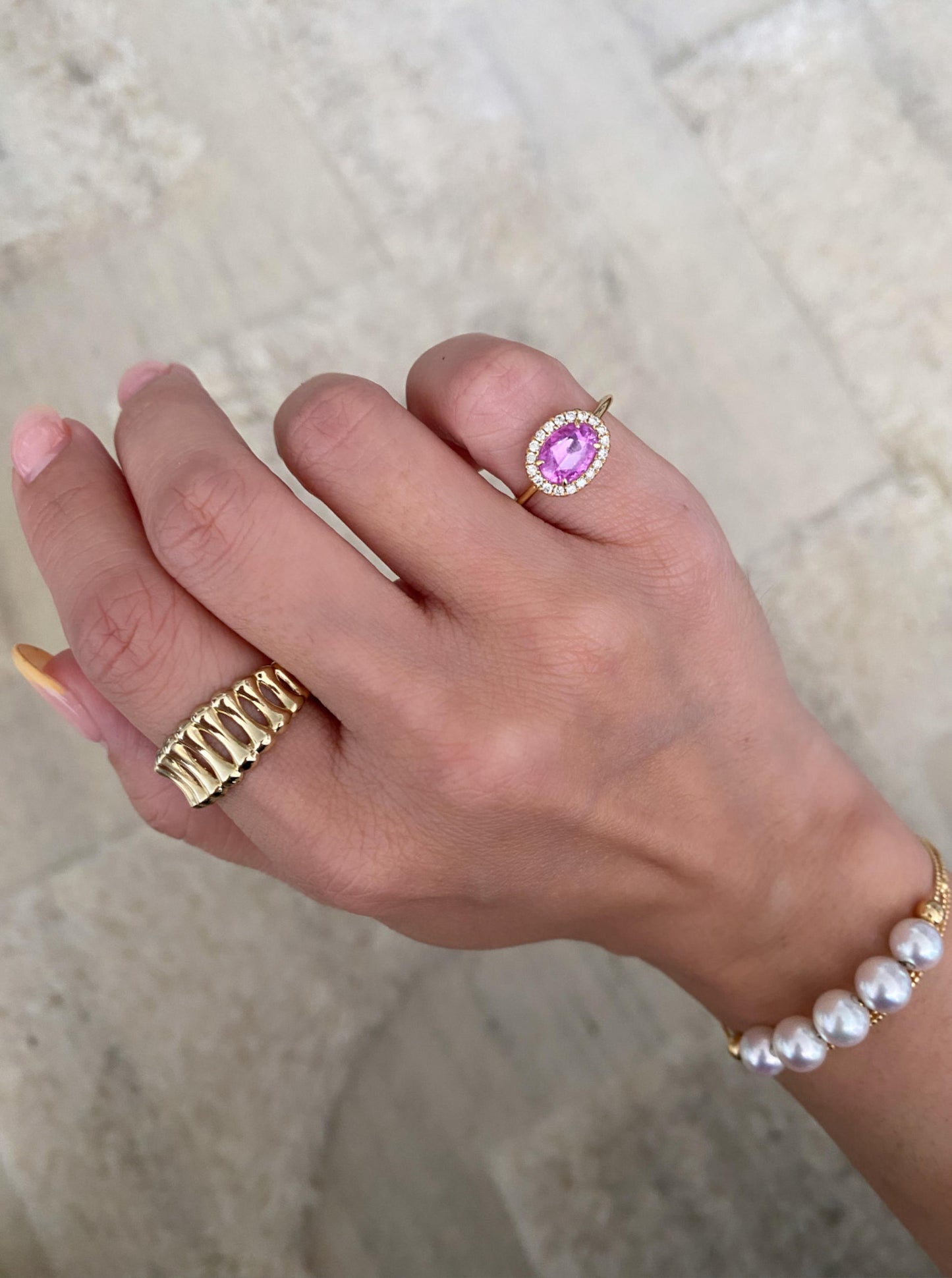 East West Oval Pink Sapphire Ring With Diamond Halo