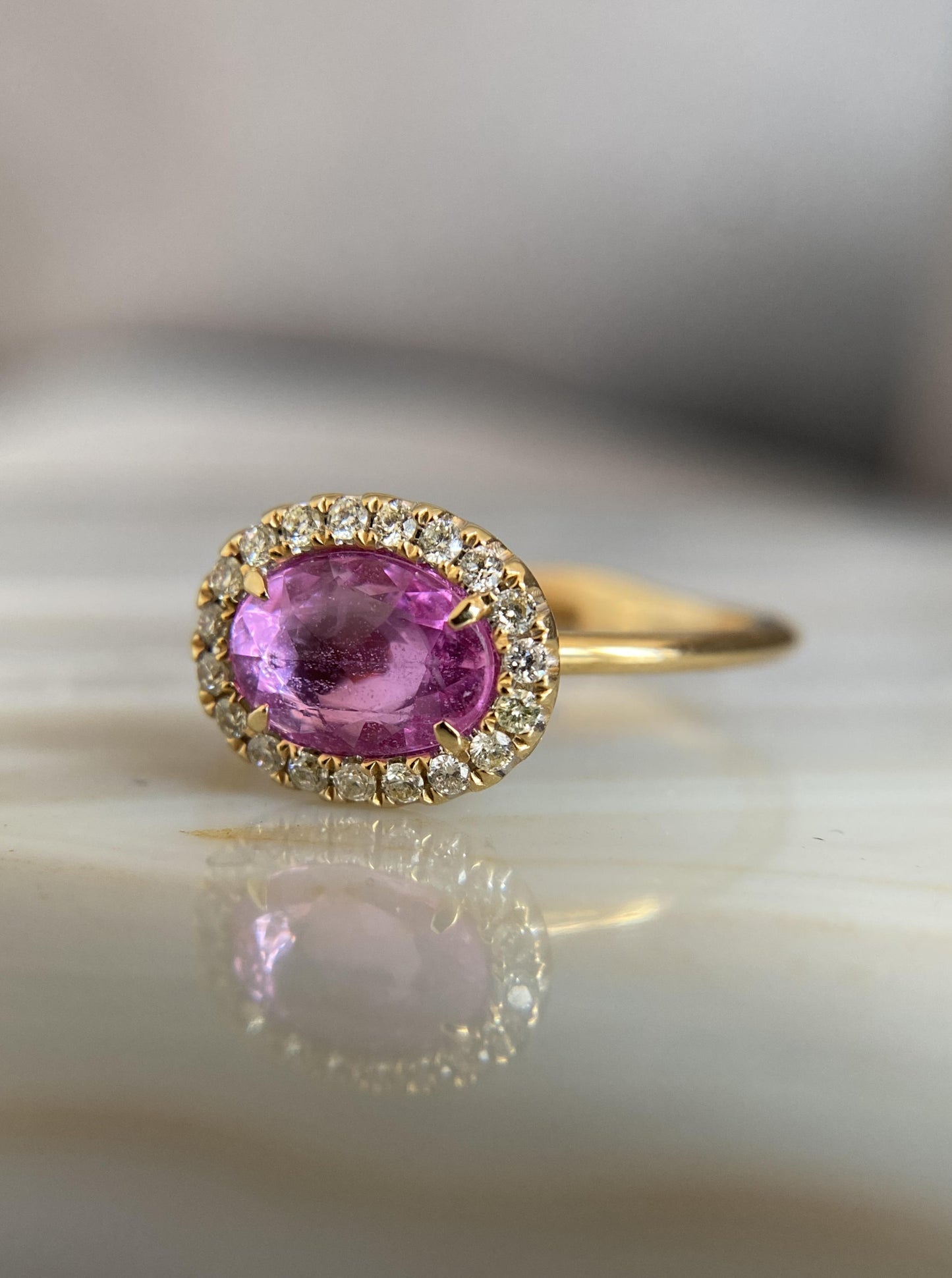 East West Oval Pink Sapphire Ring With Diamond Halo