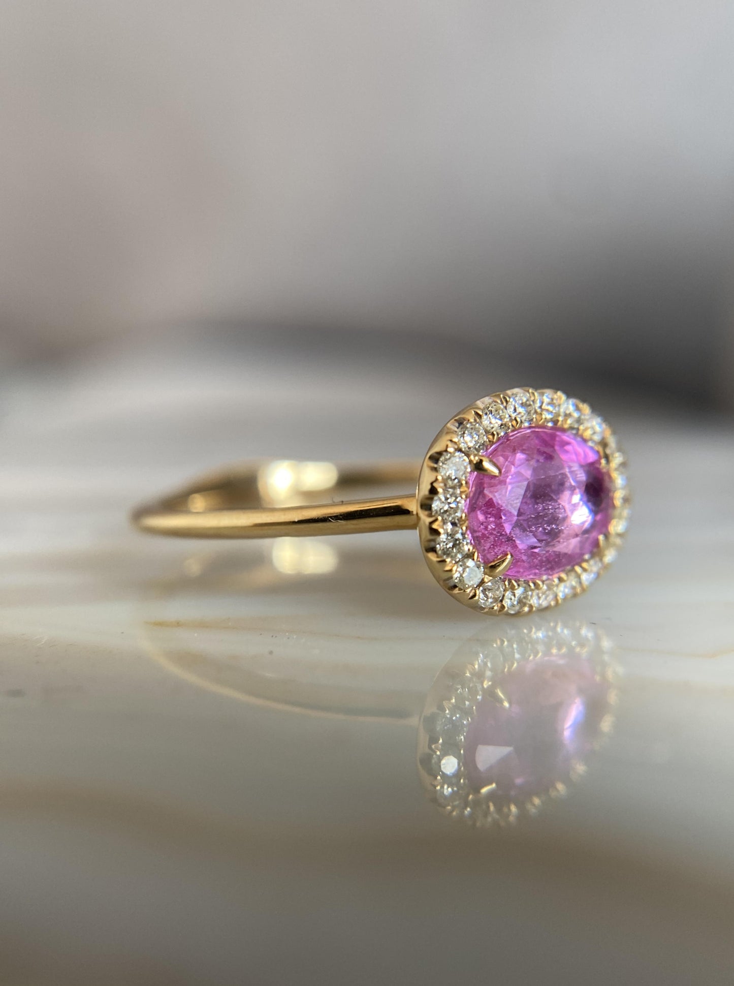 East West Oval Pink Sapphire Ring With Diamond Halo